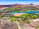 Extensive aerial view of a luxurious community boasting a golf course, lake, and scenic desert landscape at 8 Reflection Cove Dr, Henderson, NV 89011