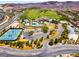 Aerial view of community amenities including a pool, tennis courts, and parking areas at 8 Reflection Cove Dr, Henderson, NV 89011