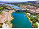 Scenic aerial view of a lakefront community with a bridge and lush landscaping at 8 Reflection Cove Dr, Henderson, NV 89011