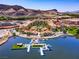 Stunning aerial view of a resort community on a lake with mountains in the background at 8 Reflection Cove Dr, Henderson, NV 89011