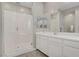 Bright bathroom with glass walk-in shower and white double vanity with mirrors at 8 Reflection Cove Dr, Henderson, NV 89011
