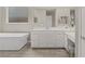 Bright bathroom with a modern soaking tub, vanity, and wood-style tile flooring at 8 Reflection Cove Dr, Henderson, NV 89011