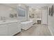 Bright bathroom featuring a soaking tub, walk-in shower, dual sink vanity, and makeup vanity at 8 Reflection Cove Dr, Henderson, NV 89011