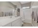 Bright bathroom with a modern white vanity, framed mirror, and shower-tub combo at 8 Reflection Cove Dr, Henderson, NV 89011