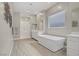 Bathroom features a soaking tub, glass enclosed shower, and white double vanity at 8 Reflection Cove Dr, Henderson, NV 89011