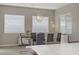Bright dining area features large windows, stylish lighting, and comfortable seating for six at 8 Reflection Cove Dr, Henderson, NV 89011