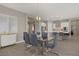 Stylish dining area with modern light fixture, glass table with seating for six, and bright natural lighting at 8 Reflection Cove Dr, Henderson, NV 89011