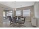 Stylish dining room with modern chandelier, glass table, and sliding doors leading to the outdoor patio at 8 Reflection Cove Dr, Henderson, NV 89011