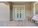 Inviting double-door entrance with paver flooring, a charming bench, and stylish decor accents at 8 Reflection Cove Dr, Henderson, NV 89011