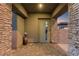 Charming front porch with stone pillars and brick pavers, creating a welcoming entrance to the home at 8 Reflection Cove Dr, Henderson, NV 89011