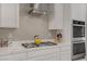 Modern kitchen features stainless steel appliances, a gas range, and stylish white countertops at 8 Reflection Cove Dr, Henderson, NV 89011