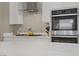 Modern kitchen features stainless steel appliances, including a double oven and a gas range, complemented by white countertops at 8 Reflection Cove Dr, Henderson, NV 89011
