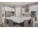 Gourmet kitchen with large center island featuring seating, stainless steel appliances, and stylish white cabinetry at 8 Reflection Cove Dr, Henderson, NV 89011