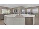Open-concept kitchen with an expansive center island, stainless steel appliances, and contemporary design at 8 Reflection Cove Dr, Henderson, NV 89011