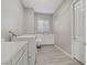 Well-lit laundry room with modern appliances, sink, and ample counter space at 8 Reflection Cove Dr, Henderson, NV 89011