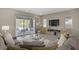 Relaxing living room features a plush gray sectional sofa and opens to a covered patio with a pool at 8 Reflection Cove Dr, Henderson, NV 89011