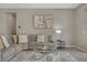 Comfortable living room features a gray sectional sofa, a glass coffee table, and stylish decor at 8 Reflection Cove Dr, Henderson, NV 89011
