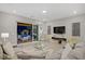 Modern living room with comfortable seating, large sliding glass doors, and sleek entertainment center at 8 Reflection Cove Dr, Henderson, NV 89011