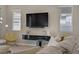 Cozy living room featuring modern decor, large windows, and a wall-mounted TV at 8 Reflection Cove Dr, Henderson, NV 89011