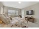 Main bedroom featuring a plush bed, neutral tones, and access to a private outdoor space at 8 Reflection Cove Dr, Henderson, NV 89011