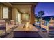 Inviting patio with a cozy fire pit, ample seating, and a refreshing pool at 8 Reflection Cove Dr, Henderson, NV 89011