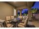 Outdoor patio area with a dining table and views of the backyard and pool at 8 Reflection Cove Dr, Henderson, NV 89011