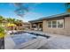 Backyard pool with spa, tropical landscaping, and a stylish lounge area at 8 Reflection Cove Dr, Henderson, NV 89011