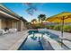Resort-style pool area with palm trees, lounge chairs, and outdoor seating at 8 Reflection Cove Dr, Henderson, NV 89011