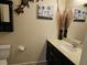 Cozy half-bathroom with single vanity and decorative wall art at 8088 Smoking Jacket Pl, Las Vegas, NV 89166
