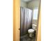 Cozy bathroom featuring a toilet, shower with curtain, and tile flooring at 8088 Smoking Jacket Pl, Las Vegas, NV 89166