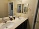 Well-lit bathroom featuring a dual sink vanity with modern fixtures and a neutral color scheme at 8088 Smoking Jacket Pl, Las Vegas, NV 89166