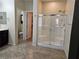 Modern bathroom featuring a glass-enclosed shower with dual shower heads and sleek fixtures at 8088 Smoking Jacket Pl, Las Vegas, NV 89166