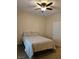 Comfortable bedroom featuring a ceiling fan and a queen bed with neutral bedding at 8088 Smoking Jacket Pl, Las Vegas, NV 89166