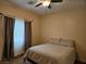 Inviting bedroom with a ceiling fan and a comfortable queen-sized bed at 8088 Smoking Jacket Pl, Las Vegas, NV 89166