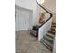 Bright entryway with tile flooring, white door, staircase and a gray accent chair at 8088 Smoking Jacket Pl, Las Vegas, NV 89166