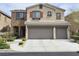 Charming two-story home with a three-car garage and stone accents at 8088 Smoking Jacket Pl, Las Vegas, NV 89166