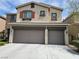 Stucco house with a two-car garage and a well-maintained lawn presents an inviting curb appeal at 8088 Smoking Jacket Pl, Las Vegas, NV 89166