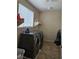 Practical laundry room equipped with modern washer and dryer units and a convenient storage shelf at 8088 Smoking Jacket Pl, Las Vegas, NV 89166