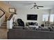 Spacious living room with comfortable seating, ceiling fan and stairs to the second floor at 8088 Smoking Jacket Pl, Las Vegas, NV 89166