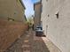 Pebbled side yard with stepping stones and equipment; functional and low-maintenance landscape design at 8088 Smoking Jacket Pl, Las Vegas, NV 89166