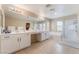 Spacious bathroom featuring double sinks, a soaking tub, and a separate glass-enclosed shower at 8112 Sapphire Sea St, North Las Vegas, NV 89085
