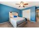 Comfortable blue bedroom featuring a platform bed with a ceiling fan and a closet at 8112 Sapphire Sea St, North Las Vegas, NV 89085