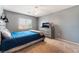 Neutral bedroom with a modern bed frame, TV and dresser at 8112 Sapphire Sea St, North Las Vegas, NV 89085