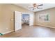 Bonus room featuring wood-look floors, ceiling fan and open double door entry to the living area at 8112 Sapphire Sea St, North Las Vegas, NV 89085