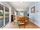 Light and airy dining area open to living room with wood floors and glass doors to backyard at 8112 Sapphire Sea St, North Las Vegas, NV 89085