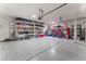 Spacious garage with ample storage shelving and epoxy flooring, perfect for organization and projects at 8112 Sapphire Sea St, North Las Vegas, NV 89085