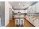 Bright kitchen features white cabinets, granite countertops, stainless steel appliances, and a center island with seating at 8112 Sapphire Sea St, North Las Vegas, NV 89085