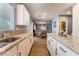 Open concept kitchen with white cabinets, granite countertops, stainless steel sink and wood floors at 8112 Sapphire Sea St, North Las Vegas, NV 89085