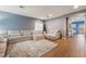Bright and airy living room with wood floors, a cozy sectional sofa, and lots of natural light at 8112 Sapphire Sea St, North Las Vegas, NV 89085