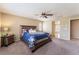 Tranquil main bedroom features ceiling fan and large windows and is adjacent to main bathroom at 8112 Sapphire Sea St, North Las Vegas, NV 89085